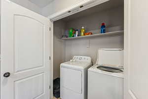Laundry room with washer and clothes dryer