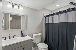 Full bathroom with vanity and toilet