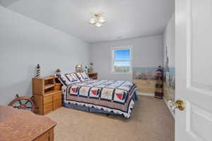 Bedroom featuring carpet flooring and baseboards