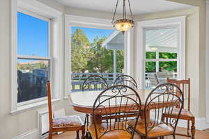 Dining space featuring wood finished floors and baseboards