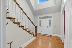 Foyer featuring light wood-style flooring and arched walkways
