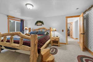 Bedroom with carpet floors and a textured ceiling