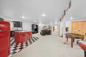 Rec room featuring light floors, recessed lighting, and light colored carpet