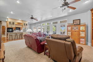Living area featuring a ceiling fan, recessed lighting, and a textured ceiling