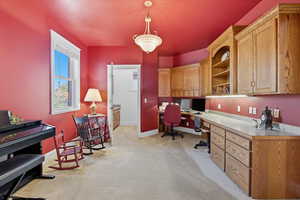 Executive Office area with light colored carpet and built in study area