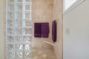 Primary Suite Bathroom featuring a walk in shower