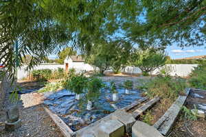 Fenced backyard featuring a vegetable garden