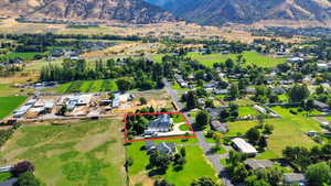 Aerial overview of property's location with property boundaries highlighted and a mountain backdrop