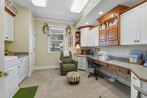 Laundry and Craft Room space with built in study area, light colored carpet, recessed lighting, and crown molding