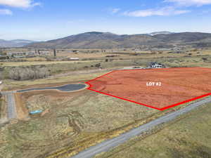 View of rural area featuring a mountainous background and property parcel outlined
