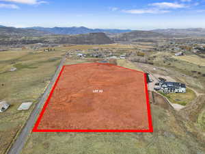 Aerial view of sparsely populated area featuring mountains and property boundaries highlighted
