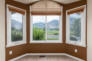 Unfurnished sunroom with a mountain view