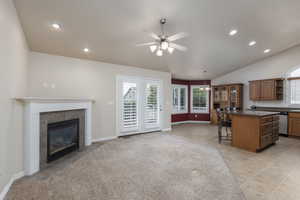 Kitchen featuring a kitchen bar, open shelves, dark countertops, recessed lighting, and a center island