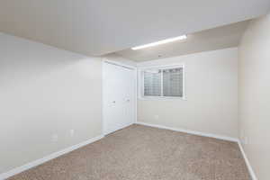 Unfurnished bedroom with carpet flooring and a closet