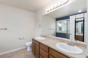 Bathroom featuring double vanity and toilet