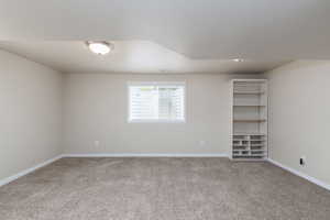 Unfurnished room featuring light colored carpet and baseboards