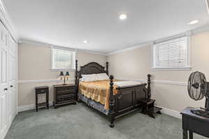 Bedroom with crown molding, light colored carpet, a closet, and recessed lighting