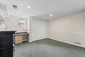 Unfurnished office with carpet, a textured ceiling, and recessed lighting