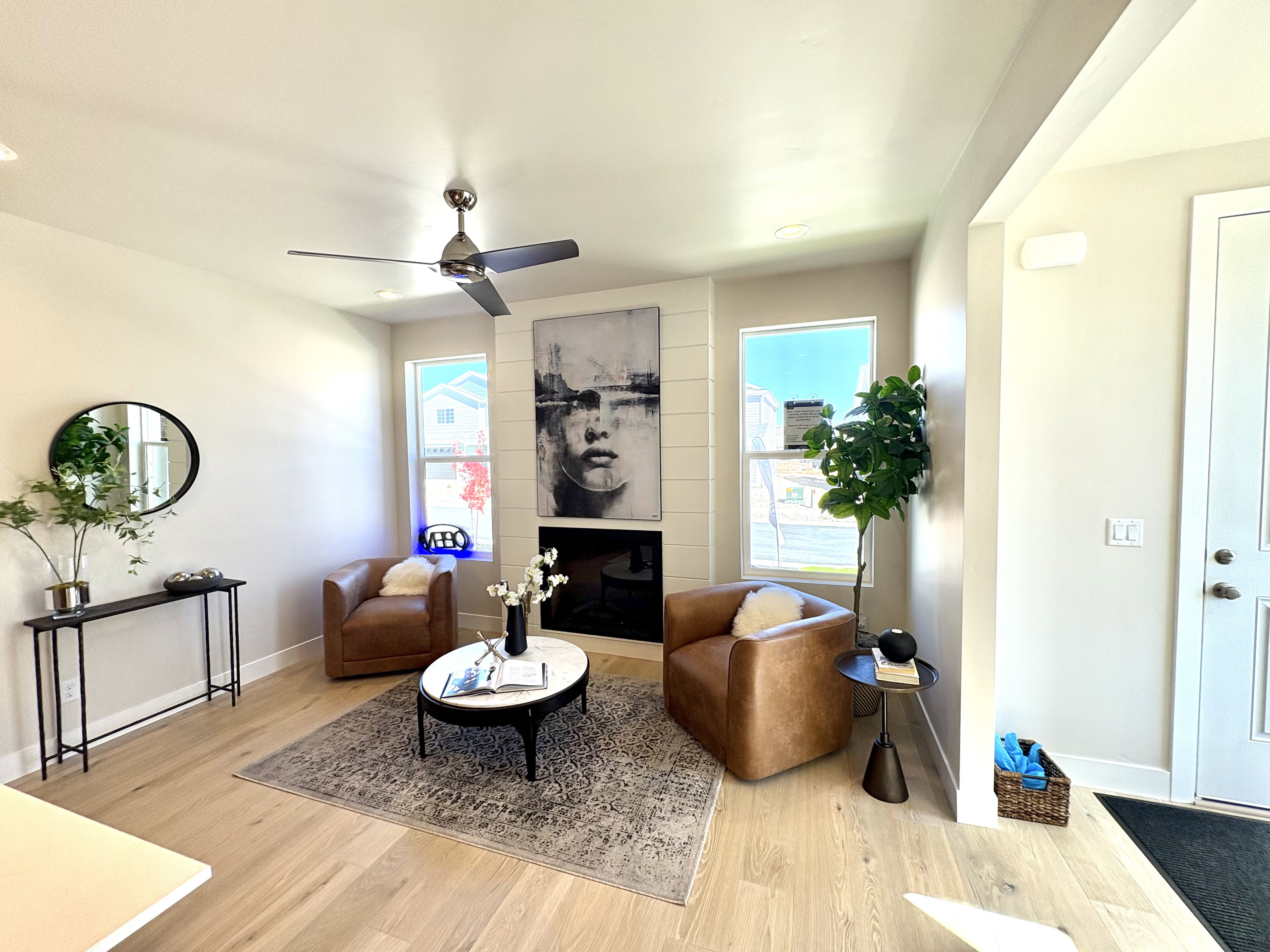 Living area featuring light wood-style floors, a fireplace, a ceiling fan, and recessed lighting