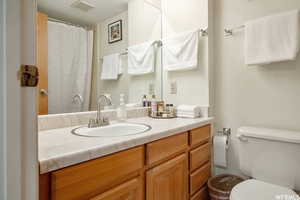 Bathroom with vanity and curtained shower
