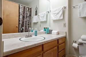 Bathroom with vanity and a shower with shower curtain