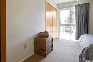 Carpeted bedroom featuring access to outside