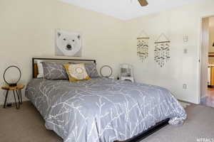 Carpeted bedroom with baseboards and a ceiling fan