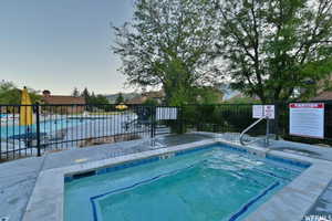 Community pool featuring a hot tub