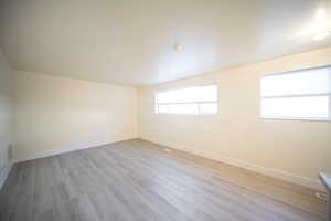 Empty room featuring light wood finished floors and baseboards