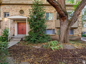 Property entrance featuring brick siding