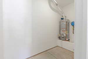 Closed in storage room at the back of 3rd car garage with water heater.