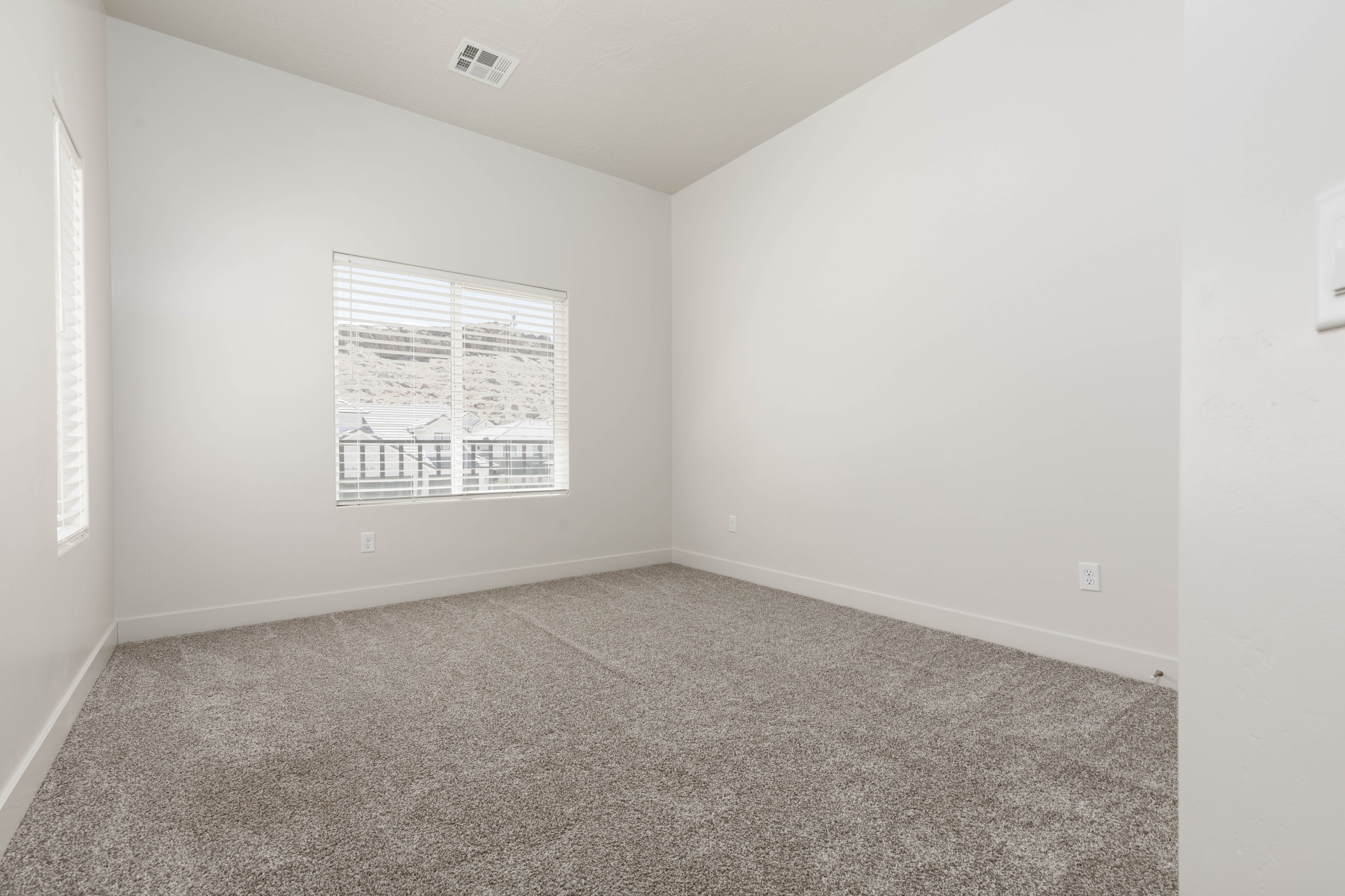 Upstairs bedroom with balcony feature.
