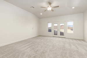 Family room with french doors, light colored carpet, lofted ceiling, a ceiling fan, and recessed lighting