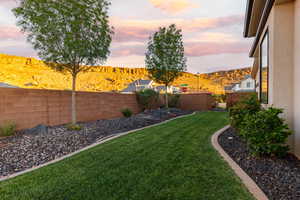 Fenced backyard featuring a mountain view