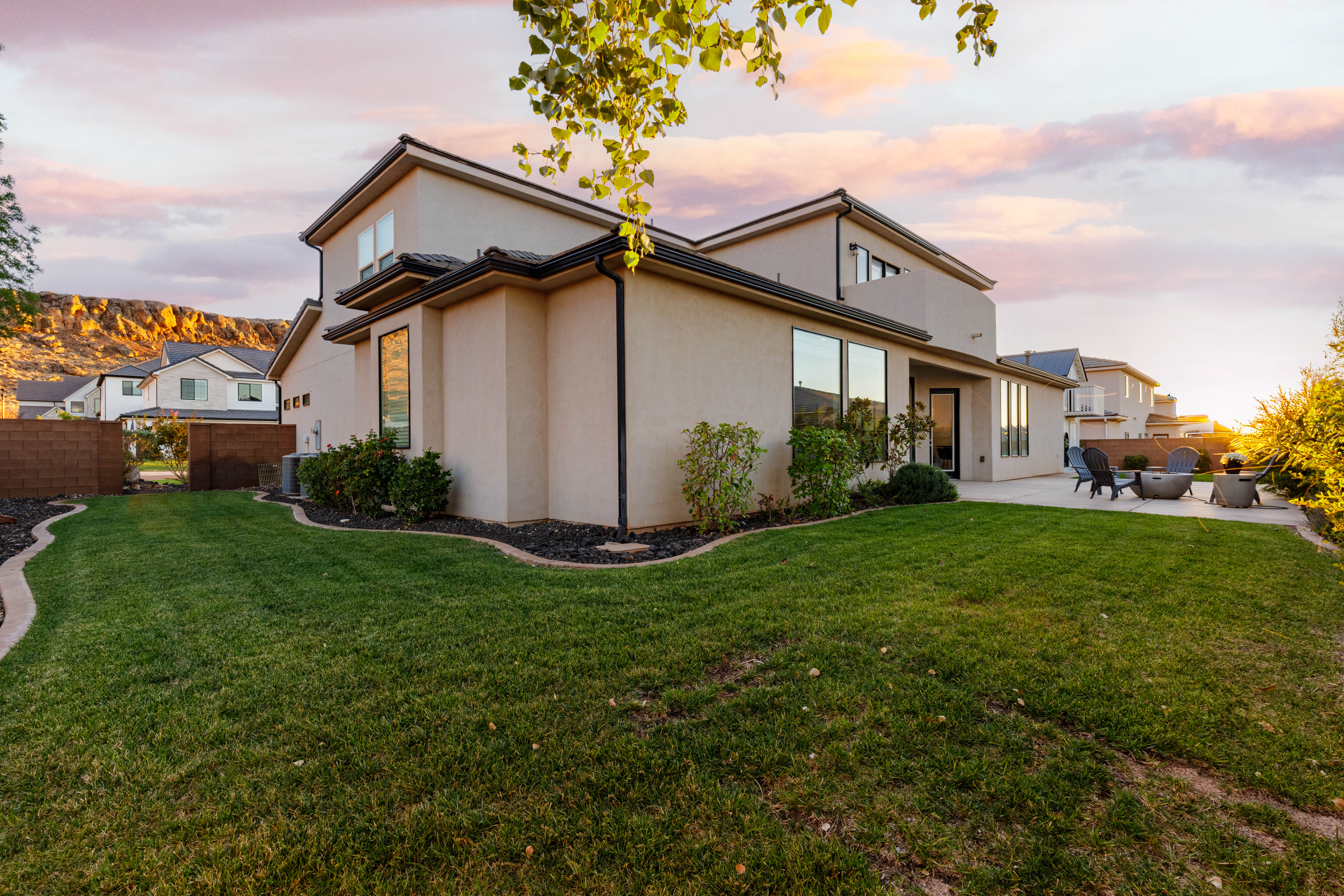 Back of property at dusk and patio area