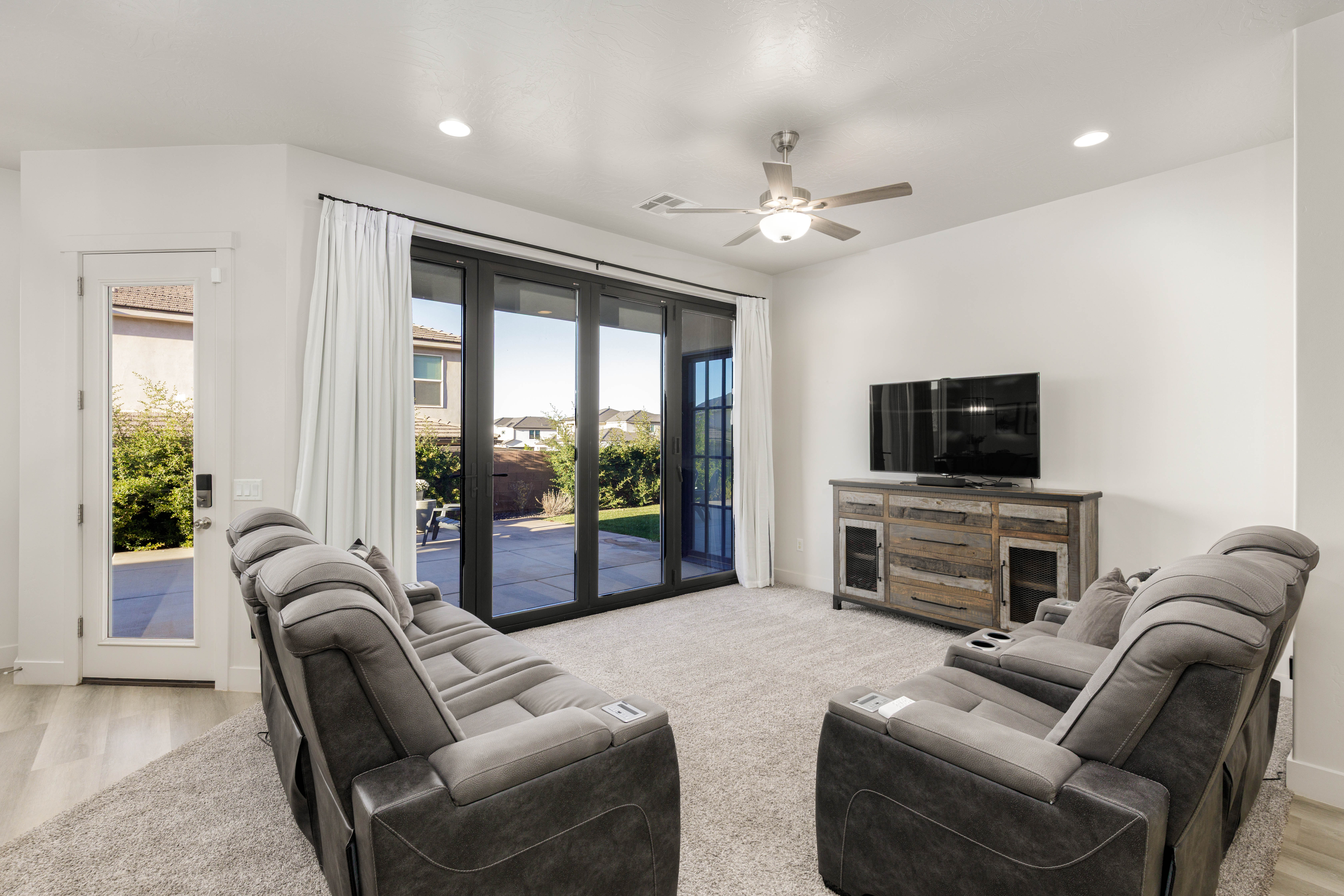 Living area with recessed lighting, ceiling fan, and light carpet