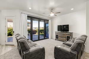 Living area with recessed lighting, ceiling fan, and light carpet