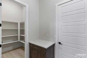 Pantry/storage with light wood-type flooring