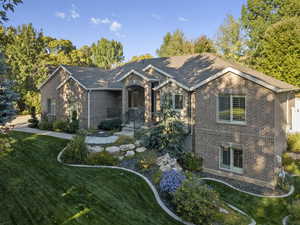 View of front of house featuring brick siding and a front yard