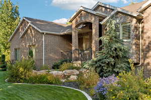 View of front facade featuring brick siding and a front lawn