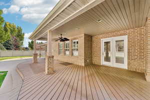 Wooden terrace featuring ceiling fan