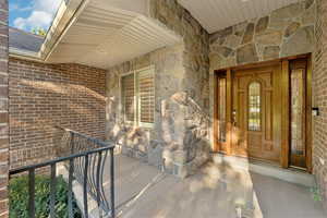 Property entrance with stone siding and brick siding