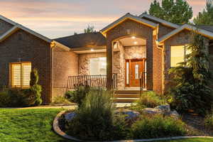 View of front of property featuring stone siding and brick siding
