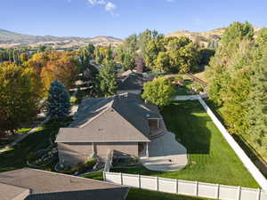 Aerial view of property and surrounding area featuring mountains