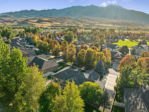 Aerial overview of property's location with nearby suburban area and a mountain backdrop