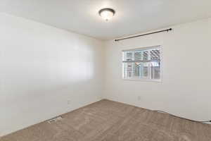 Unfurnished room featuring carpet flooring
