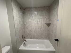 Full bath featuring shower / washtub combination and toilet