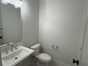 Half bathroom featuring a sink and tile patterned floors