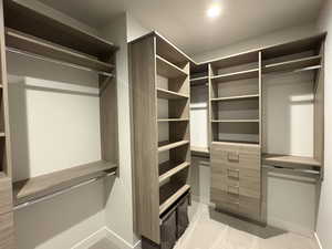 Spacious closet with light colored carpet