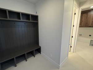 Mudroom with baseboards and light floors